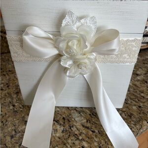 Elegant off white wedding card box with ribbon and floral accents.